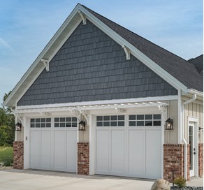 A carriage house style garage door with decorative hardware