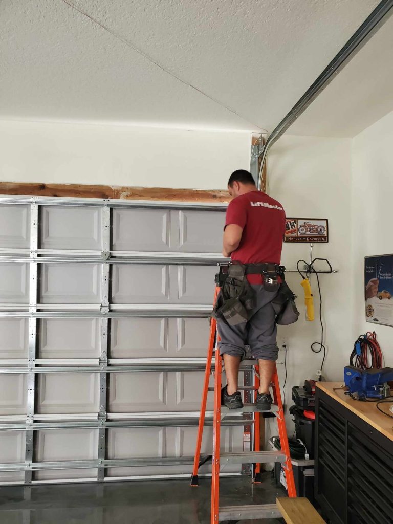 Trinity technician on a garage door repair in Oldsmar