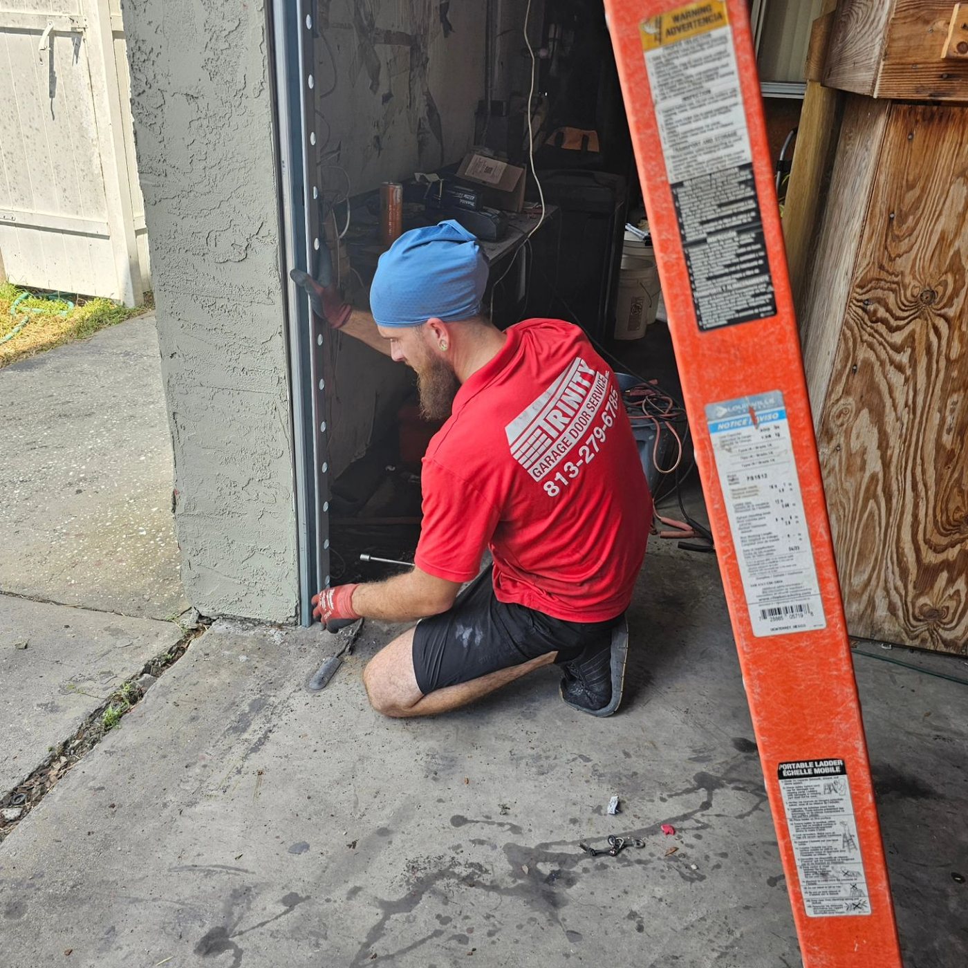 Trinity technician repairing an off-track garage door