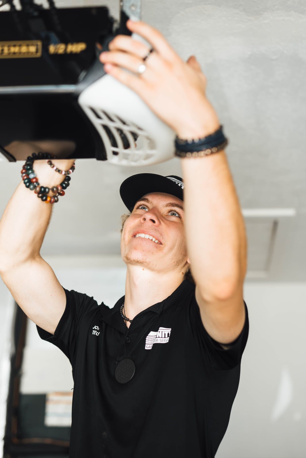 Trinity technicians servicing a garage door opener