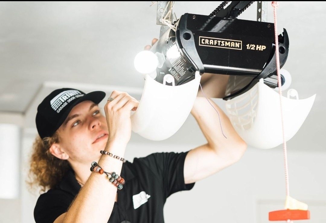 Trinity technician servicing a ceiling mounted garage door opener