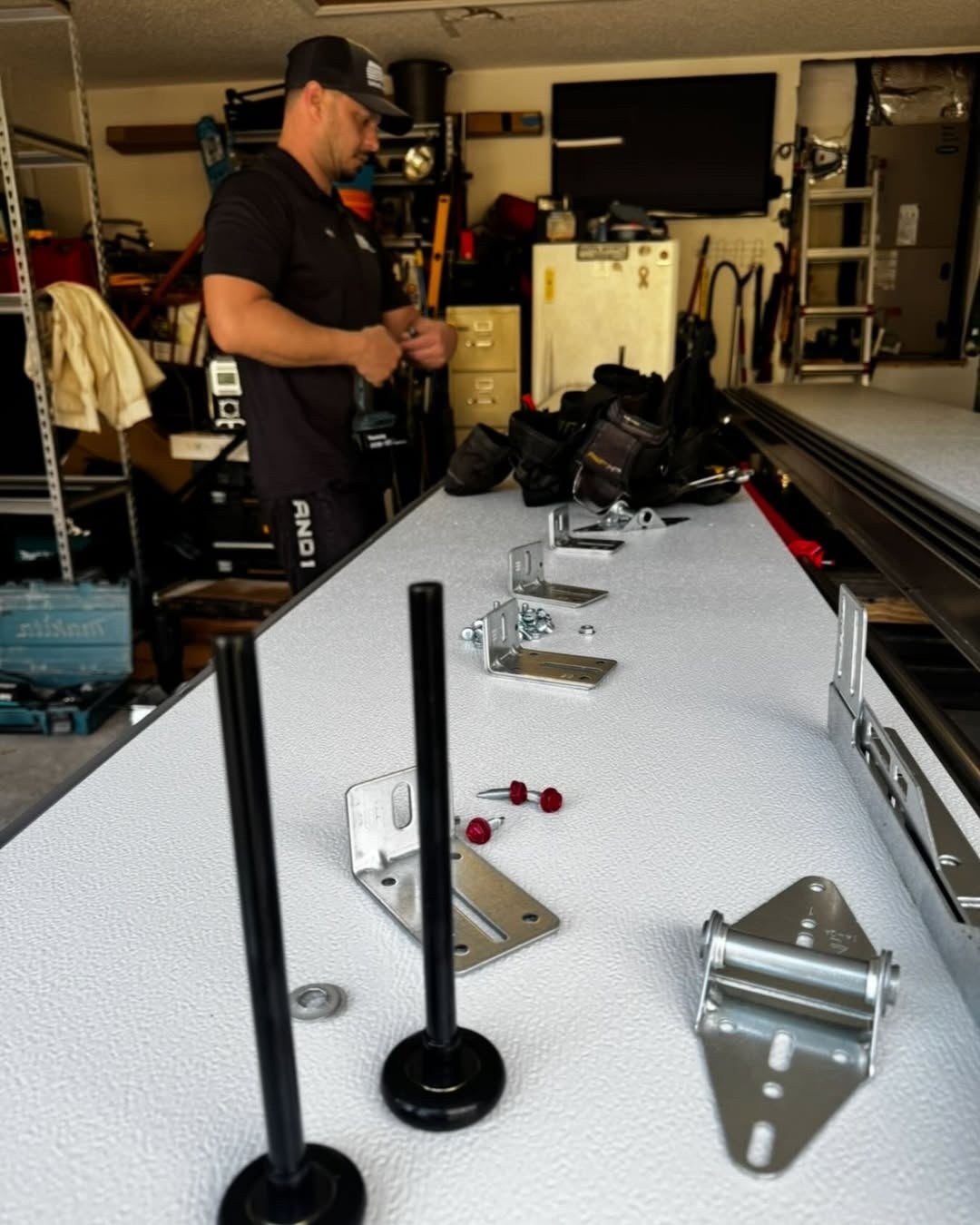New rollers, hinges and roller brackets laid out before a Trinity replacement