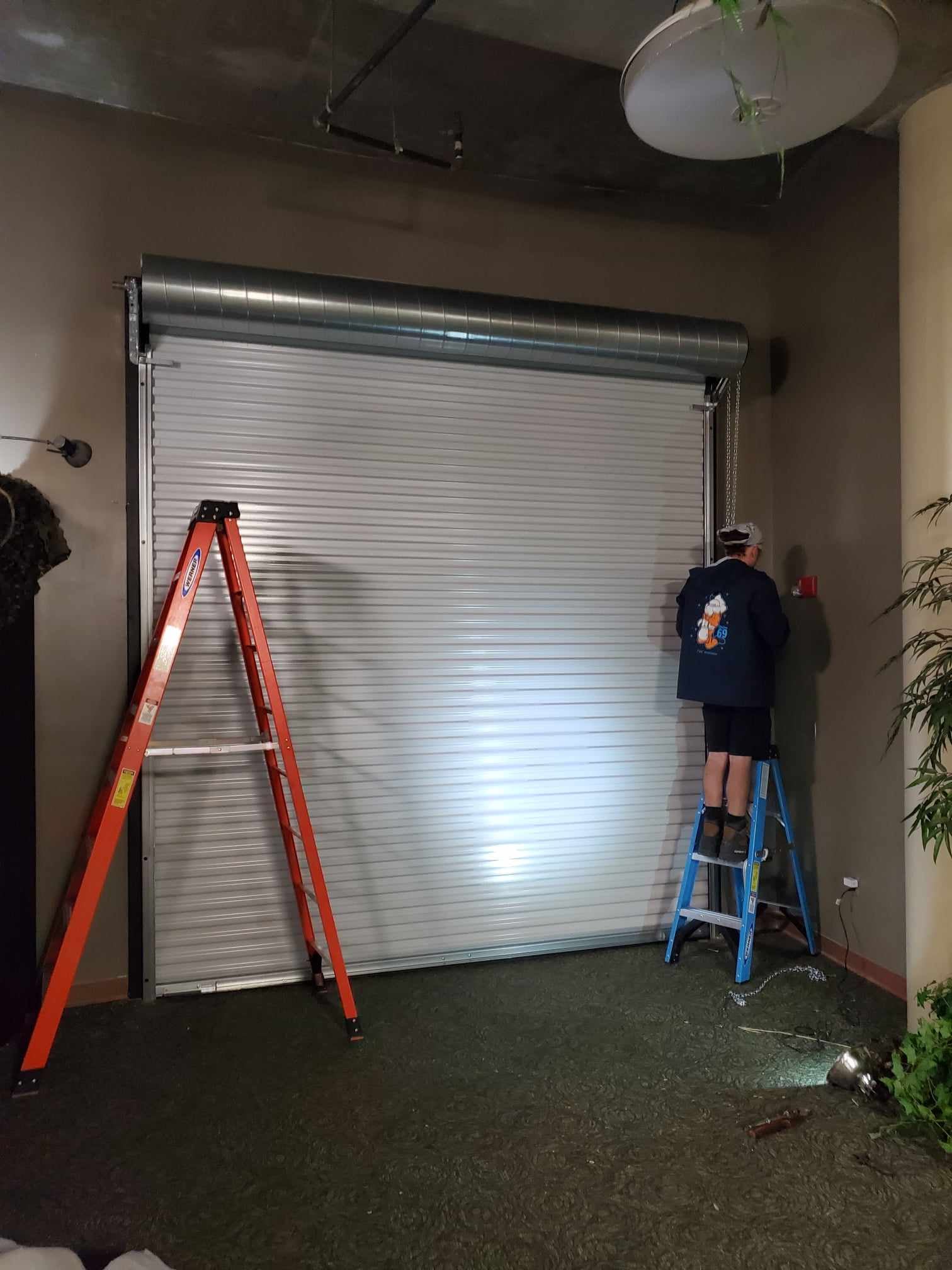 A Trinity technician repairing a garage door in Lutz