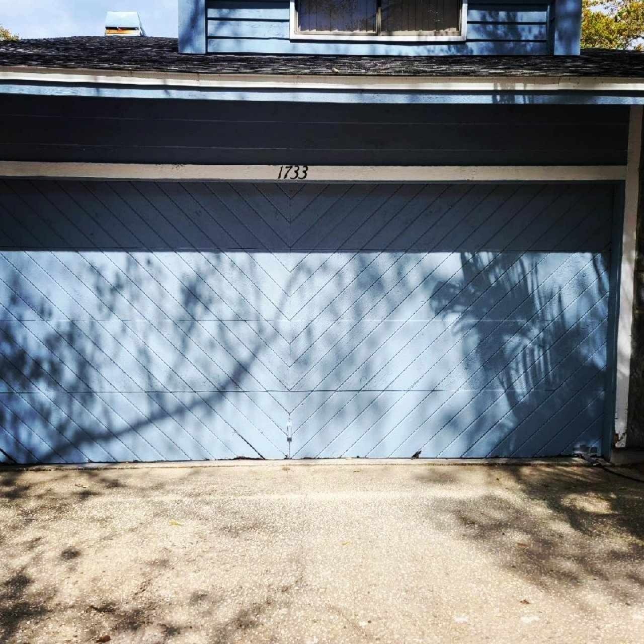 Before: garage door replaced with a white sectional door
