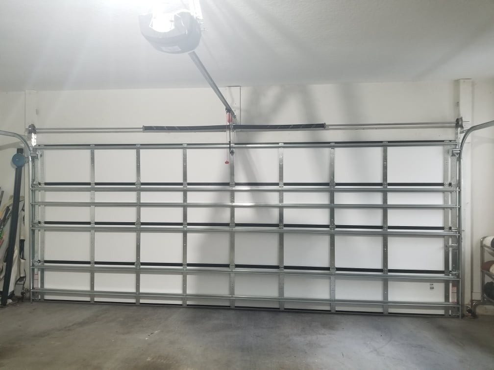 An open garage door showing the rail and rollers from inside
