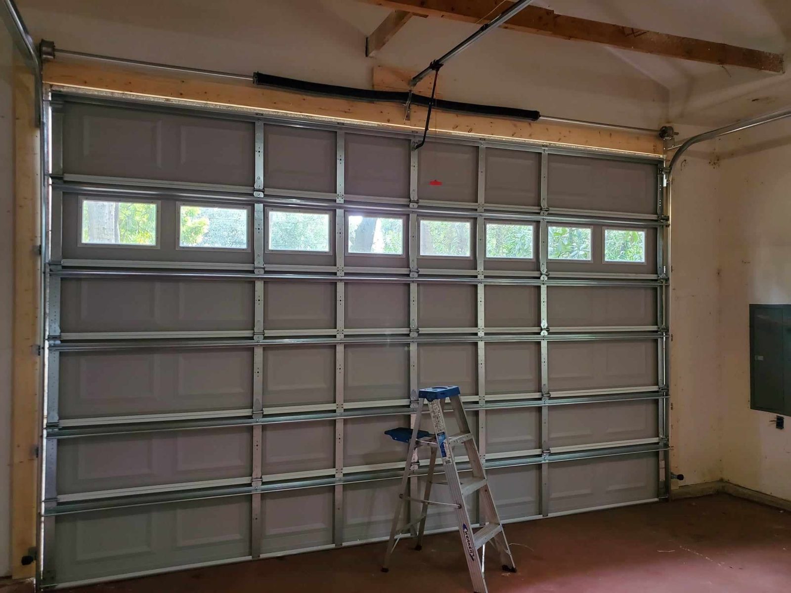 The inside of a garage door with a row of window panels
