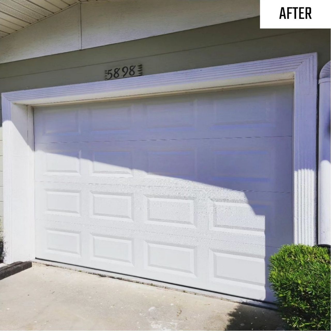 A clean white two car garage door on a Florida home